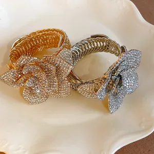Detailed view of luxurious gold and silver flower bangles encrusted with sparkling rhinestones