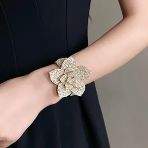 Detailed view of luxury 3D flower cuff bangle with sparkling rhinestone inlay on wrist