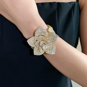 Close-up of a sparkling rhinestone flower cuff bracelet worn elegantly on a wrist