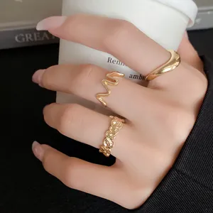 Close-up view of irregular geometric gold-tone open rings for a minimalist aesthetic
