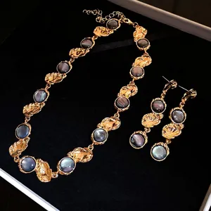 Vintage gold-textured collar necklace and drop earrings set with grey resin inlays
