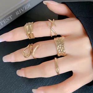 Close-up of gold irregular geometric open rings set on female hand for a luxury look
