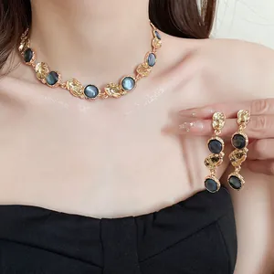 Detailed view of vintage gold-tone necklace and earrings set with grey resin circles
