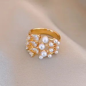 Detailed macro shot of French vintage gold open ring featuring pearls and clear zirconia