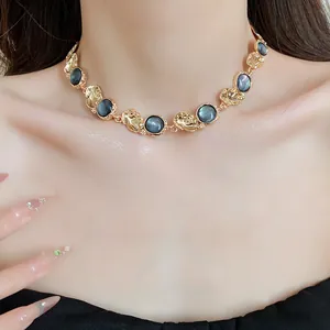 Close-up of vintage palace style choker necklace with gold metal and grey resin stones