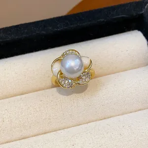 Close-up of a French vintage pearl ring with shimmering diamond accents in a jewelry box