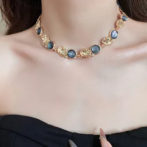 Close-up of a vintage-inspired gold choker necklace with elegant grey resin circular inserts
