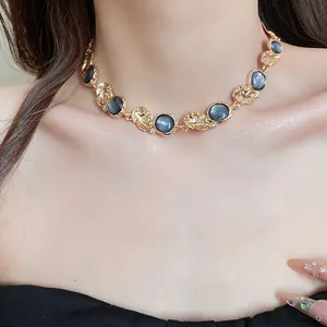 Close-up of vintage resin necklace with gold-toned hammered links on model's neck