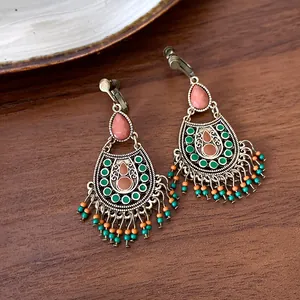 Detailed view of ethnic style tassel earrings with colorful beads and vintage bronze finish