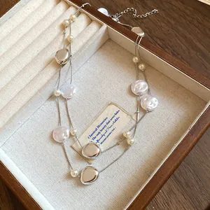 Detail of French retro necklace with white pearls and silver beads in a wooden box
