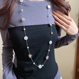 Detailed close-up showing a French vintage round pearl beaded necklace on a model
