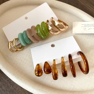 Detailed shot of vintage Maillard resin and gold-tone earring set on display cards