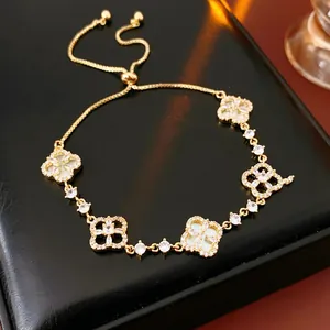 Bracciale vintage in oro con motivo a quadrifoglio, zirconi e catena regolabile