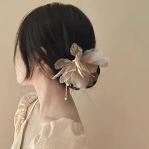 Detail view of a vintage chiffon flower hairpin with elegant pearl tassel for women