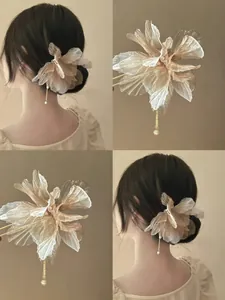 Detailed view of an elegant chiffon flower hair pin with a delicate pearl tassel.