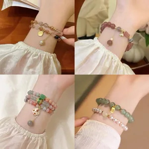 Detailed view of multiple New Chinese style beaded bracelets with fox and fortune charms