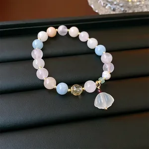 Elegant multi-color crystal bead bracelet with a translucent lily-of-the-valley charm detail
