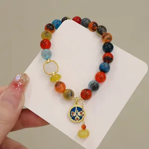 Macro view of a colorful crystal bead bracelet with a blue eye-motif pendant