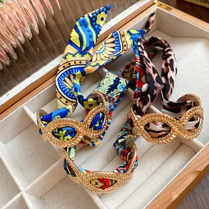 Exotic retro alloy bracelets with colorful silk ribbon streamers shown in a jewelry box