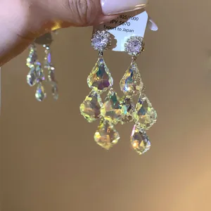 Detailed macro shot of elegant royal court style silver earrings with iridescent crystals