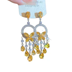 Luxury palace style silver zircon earrings featuring vibrant yellow butterfly tassels design