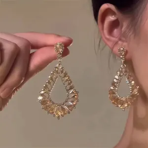 Detailed macro view of luxury champagne zircon teardrop earrings in vintage court style