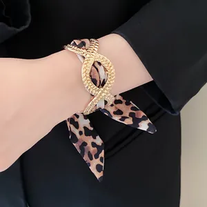 Leopard print silk scarf bracelet with gold textured metal buckle detail