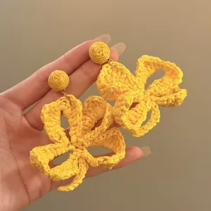 Bright yellow raffia woven flower pendant earrings for seaside beach resort style