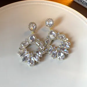 Detailed macro shot of vintage-style gold earrings with sparkling clear zirconia