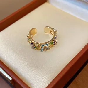 Detailed shot of the intricate enamel flower design on this 18K gold plated ring.