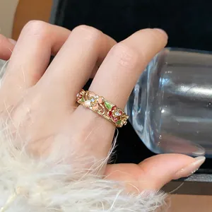 Detailed macro view of an elegant 18k gold plated enamel flower ring with rhinestones.