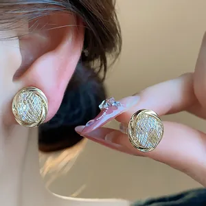 Close-up of elegant 18k gold plated zircon geometric clip-on earrings worn on model's ear
