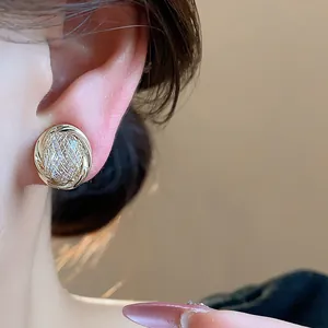 Macro view of 18k gold plated zircon geometric ear clip featuring fine mesh detail