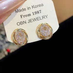 Detailed view of 18k gold plated geometric clip-on earrings with sparkling zircons