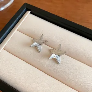 Elegant silver star stud earrings with textured metallic finish