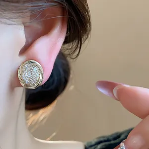 Close-up of elegant 18k gold-plated zircon ear clip with intricate textured design