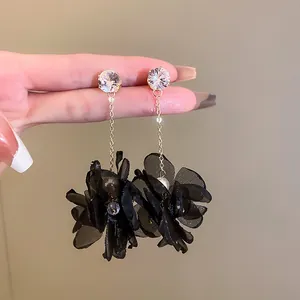 Elegant black mesh flower earrings with dangling gold tassel and delicate pearl accents