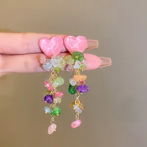 Detailed close-up of vibrant colorful stone tassel earrings with pink heart tops