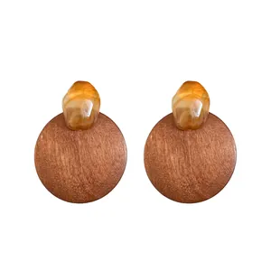 Elegant vintage round wooden stud earrings featuring amber resin accents in Maillard style.
