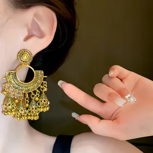 Vintage gold-finished fan-shaped earrings featuring delicate dangling bell tassels detail