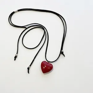 Elegant red resin heart pendant necklace with an adjustable black cord for women