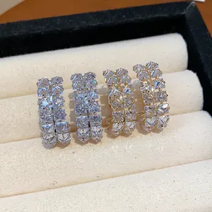 Close-up of double-row cubic zirconia hoop earrings in gold and silver finishes