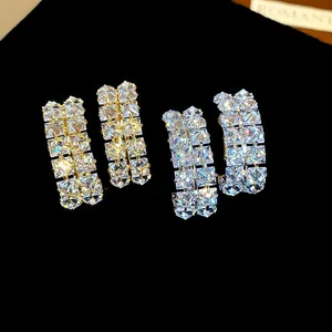 Macro detail of sparkling double-row square-cut cubic zirconia hoop earrings for women