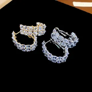 Close-up of elegant double-row zircon oval hoop earrings with silver needle posts.