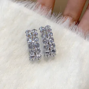 Close-up of silver needle earrings featuring double rows of sparkling clear cubic zirconia.