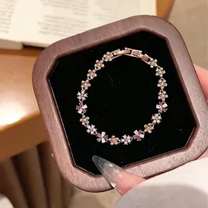 Macro detail of French style zircon flower and pearl bracelet in a wooden gift box