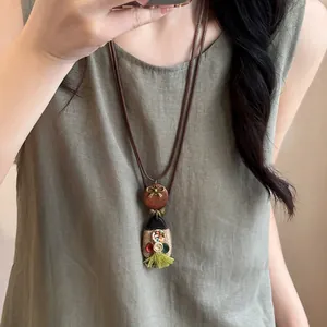 Vintage bohemian wax cord necklace with camera butterfly pendant on a female model