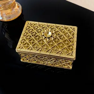 Luxurious ornate vintage golden metal jewelry box with hollow filigree design for trinkets