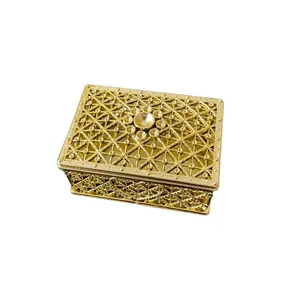 Elegant ornate golden metal jewelry box with hollow lattice design for rings and earrings