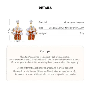 Detail view of 18K gold plated popcorn earrings with pearl and zircon specifications